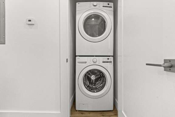 A white washing machine and dryer in a laundry room.