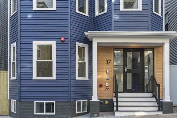 A blue house with the number 17 on the door.