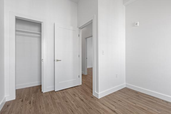 A room with a white door and a white wall.