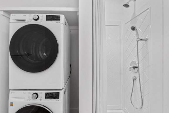 A white washing machine and dryer in a laundry room.