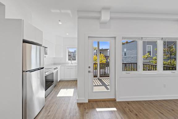 A modern kitchen with a refrigerator, oven, and sink.