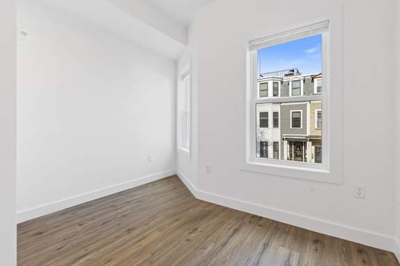 Empty room with a window showing a building outside.
