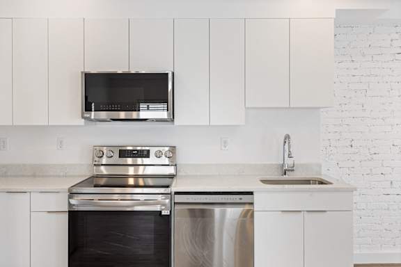 A modern kitchen with a stainless steel oven and dishwasher.