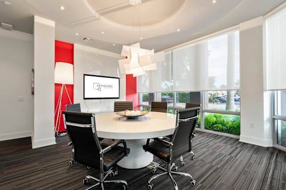 A conference room with a table and chairs.