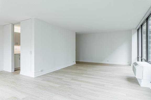 A white room with a sliding door and a window.