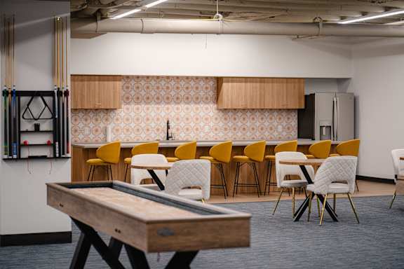 A conference room with a long table and chairs.