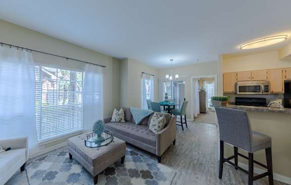 A living room with a grey couch and a grey chair.