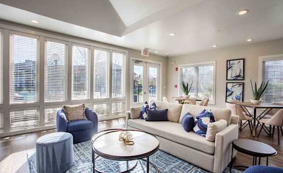 A living room with a couch, chairs, and a coffee table.
