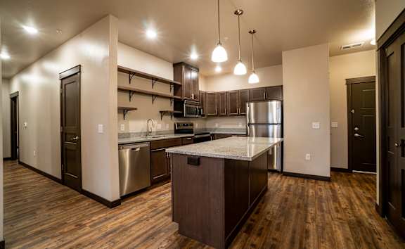 A kitchen with wooden floors and a center island.