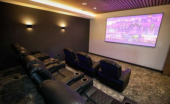 A home theater with a large screen and comfortable seating.