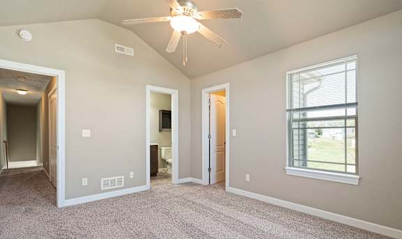 A room with a ceiling fan and a window.