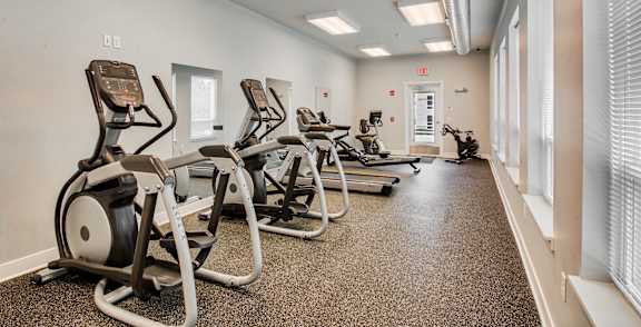 A gym with treadmills and exercise equipment.