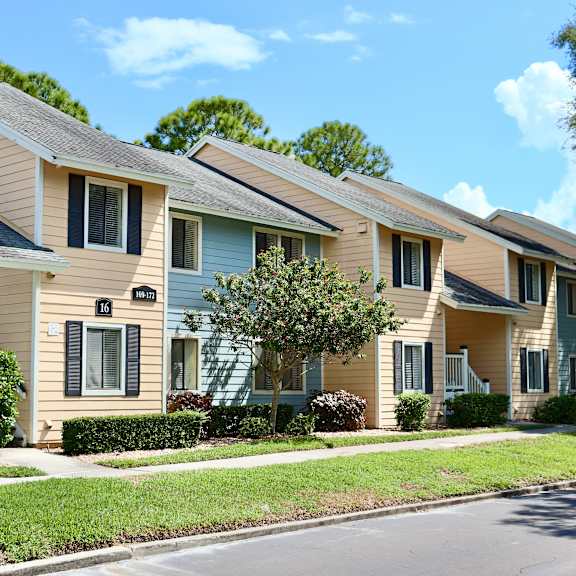 A row of houses with a clear blue sky above them.