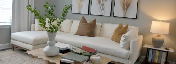 a living room with a white couch and a table