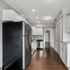 a kitchen and living room with a table and a tv