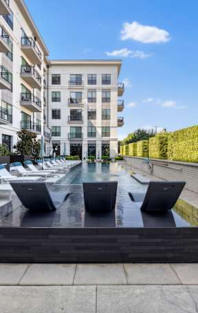 A modern outdoor seating area with a water feature in the center.