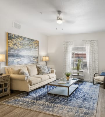 a living room with a couch a coffee table and a tv