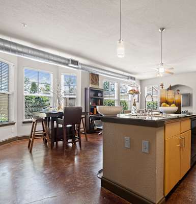 a kitchen with a large island in the middle of a living room at The Millennium Towne Center Apartments, Louisiana 70806