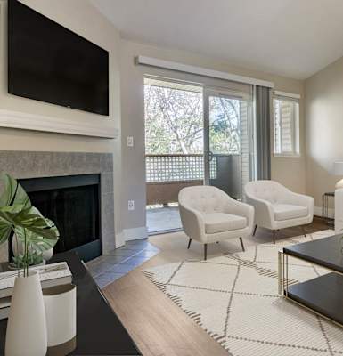 a living room with a couch chair coffee table and fireplace