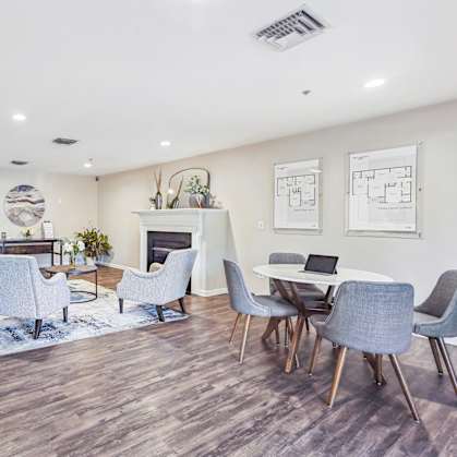 A modern living room with a fireplace and a dining table set up.