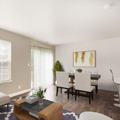 A living room with a couch, a coffee table, and a dining table.