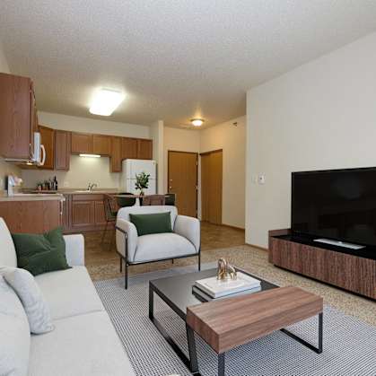 a living room with a couch and a coffee table. Fargo, ND North Sky Apartments