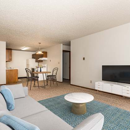 a living room with a couch and a table and a television