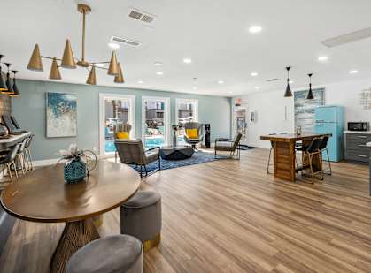 a living room with a dining room and a kitchen with a table and chairs