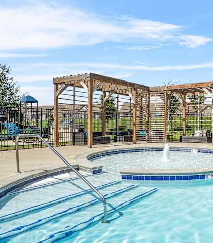 A pool with a slide and a gazebo.