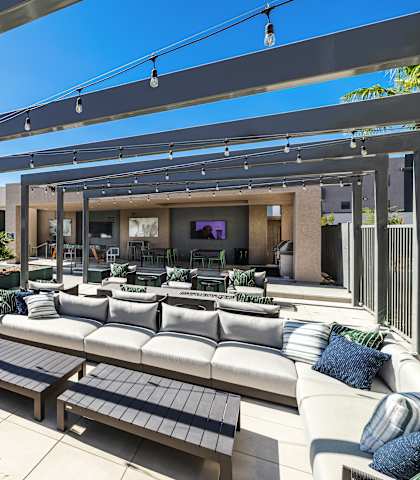 A modern outdoor living space with a pool and lounge area.