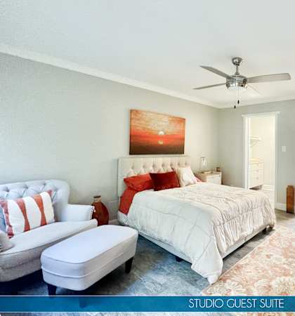 a bedroom with a bed and a ceiling fan