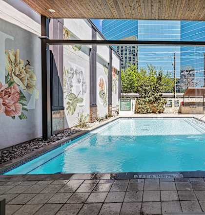 A swimming pool with a wooden ceiling and tiled floor.