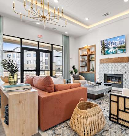 A living room with a fireplace and a TV on the wall.