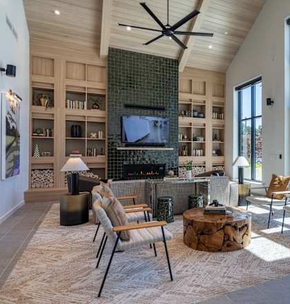 A modern living room with a fireplace and a television.