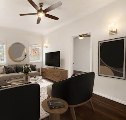 A living room with a black chair and a grey couch.