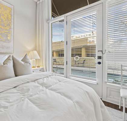 a bedroom with a large bed and a window