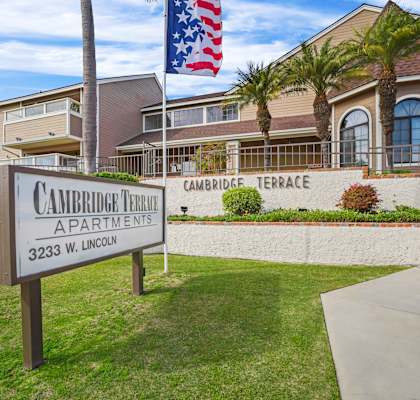 A sign for Cambridge Terrace Apartments stands in front of a building.