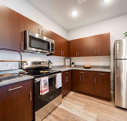 a kitchen with stainless steel appliances and wooden cabinets