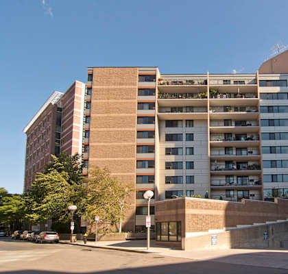 an apartment building on the corner of a city street