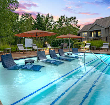 Pool view with lounge chairs at Stonepost Ranch Apartments, Overland Park, 66221
