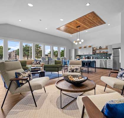 a living room with couches and chairs and a kitchen