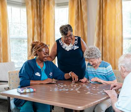 a group of nurses playing a game at a table