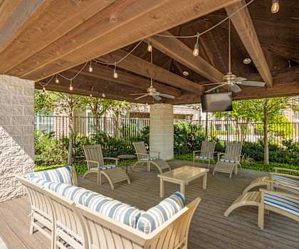 Wooden patio with chairs at Ovation at Lewisville Apartment Homes, Lewisville, 75067