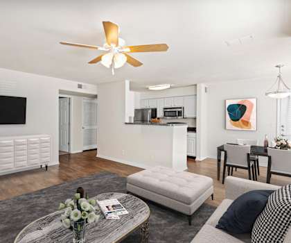 a living room with white walls and a ceiling fan at Stonebriar Woods Apartments, Overland Park, KS