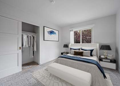 A bedroom with a large bed and a painting on the wall at Hillsdale Garden Apartments, CA 94403