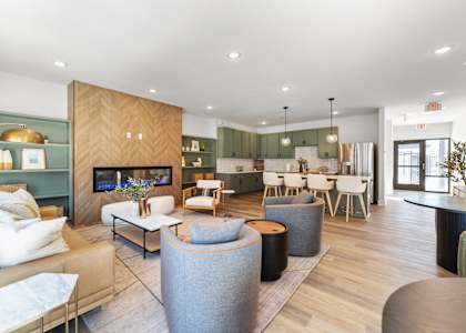A modern living room with a wooden cabinet and a grey sofa.