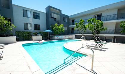 a swimming pool in front of an apartment building