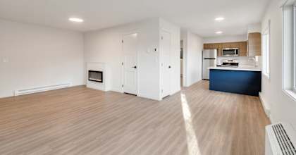 an empty living room and kitchen in a new home