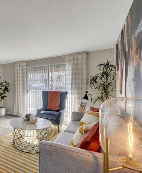 A bedroom with a bed, a shelf, and a doorway leading to another room at Parkway at Silverado Ranch, Las Vegas, NV.