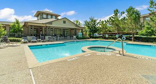 our apartments have a resort style swimming pool with a clubhouse in the background
